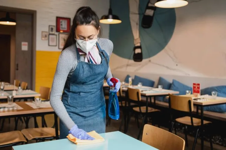 Professional cleaner sanitizing an insured motel and hotel in Edmonton and Calgary – Ecora Cleaning